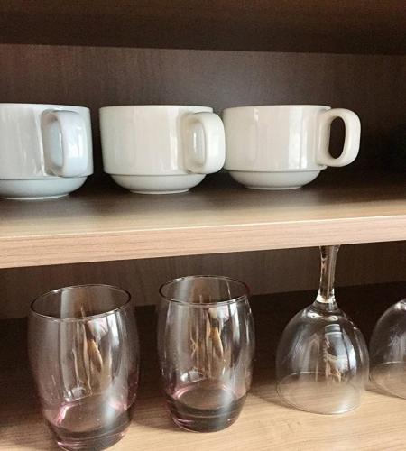 a shelf with three wine glasses and bowls on it at La Foret Fujimi - Vacation STAY 45794v in Hiroshima