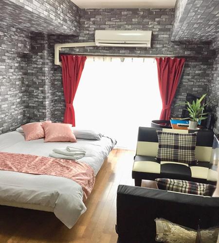 a bedroom with two beds and a window at La Foret Fujimi - Vacation STAY 45794v in Hiroshima