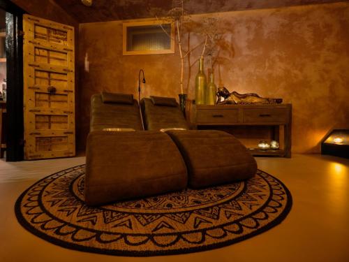 a living room with a couch and a rug at Dreams and Wellness in Vorstenbosch