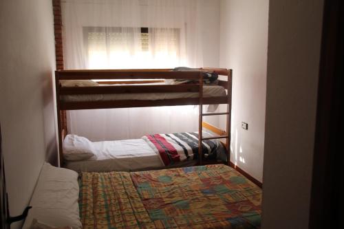 two bunk beds in a room with a window at ENTRE NARANJOS in Los Barrios