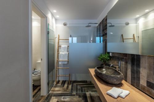 a bathroom with a sink and a mirror at DeKo Villa Mykonos in Ano Mera