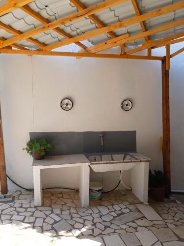 a bench sitting in the middle of a patio at AGATHA appartments PALIOURIA in Kókkinon Nerón
