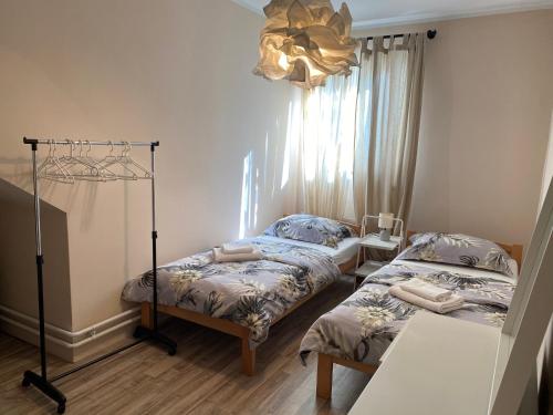 een slaapkamer met 2 bedden en een kroonluchter bij Rijeka holiday home in Krasica