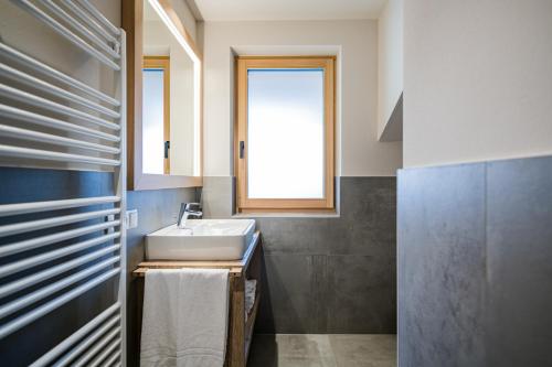 a bathroom with a sink and a window at Stöfflerhof in San Candido