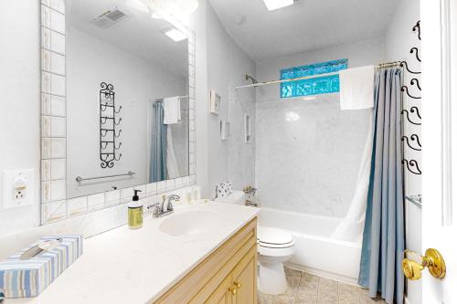 a white bathroom with a sink and a toilet at Ashley Haven in Folly Beach