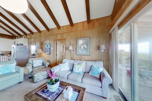 a living room with a couch and a table at Best Hall Around in Holden Beach