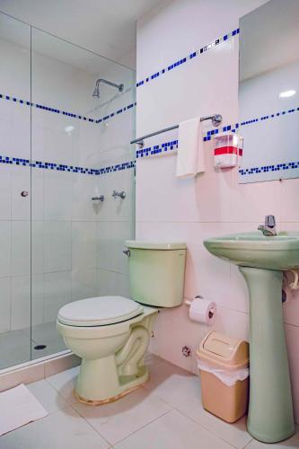 a bathroom with a toilet and a sink and a shower at Luna Cartagena Airport Hotel in Cartagena de Indias