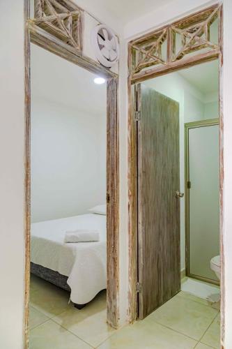 a bedroom with a mirror and a bed in it at Luna Cartagena Airport Hotel in Cartagena de Indias