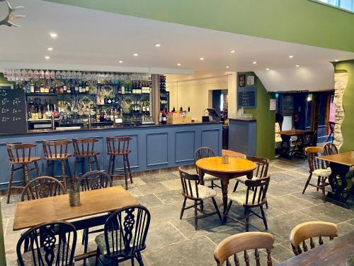 a restaurant with tables and chairs and a bar at The Lion at West Pennard in West Pennard