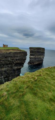 two large rocks in the water near the ocean at Ferry View Cottage in Belmullet