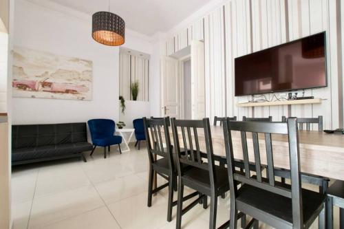 a living room with a dining room table and chairs at Premium Apartment by Hi5-Vaci str. 3 bedroom (218) in Budapest