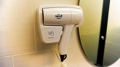 a hair dryer is plugged into a wall at Smile Hotel Danau Kota in Kuala Lumpur