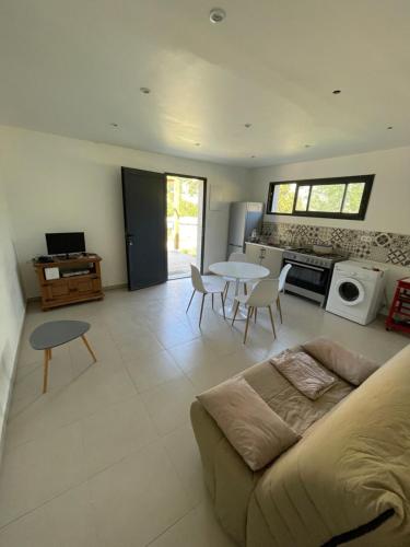 a living room with a couch and a table at Casa Prunelli 2 in Omessa