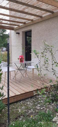 a wooden deck with a table and chairs on it at Casa Prunelli 2 in Omessa