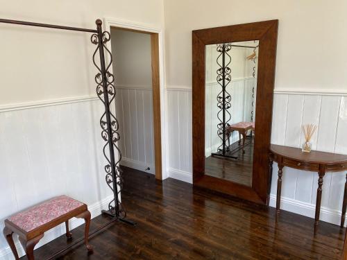 a room with a mirror and a stool and a table at Seacroft Estate in Apollo Bay