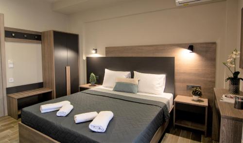 a bedroom with a bed with two towels on it at Villa Morfeas in Paralia Katerinis