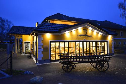 a house with a bench in front of it at night at Perbersdorfer Heuriger in Neuhofen an der Ybbs