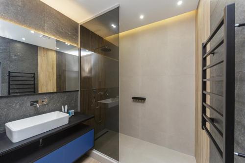 a bathroom with a sink and a mirror at Level 24 - Sea & Sky View Apartment in Odesa
