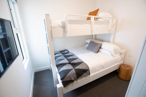 a small bedroom with bunk beds in a house at Mt Buller Chalet Hotel & Suites in Mount Buller
