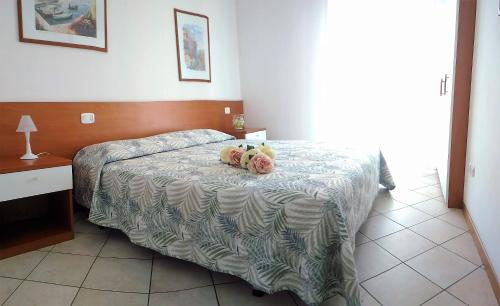 een slaapkamer met een bed met twee teddyberen erop bij Green Holiday Flat with pool close to the beach in Bibione