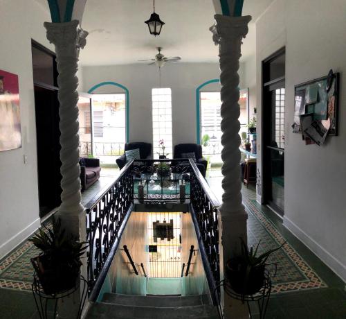 a hallway with a spiral staircase in a house at MEDUSA'S HOSTEL in Aguadilla