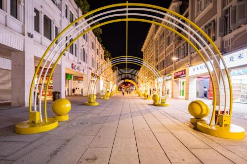 an empty street with a row of yellow barriers at Ibis Styles XM Zhongshan Hotel in Xiamen