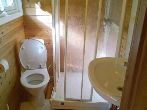 a small bathroom with a toilet and a sink at Two-Bedroom Holiday home in Engavågen 1 in Åmnes