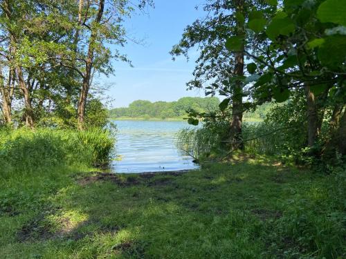 a view of a river with trees and a field at K 357 - Low budget Hotel in Ratekau bei Lübeck in Ratekau
