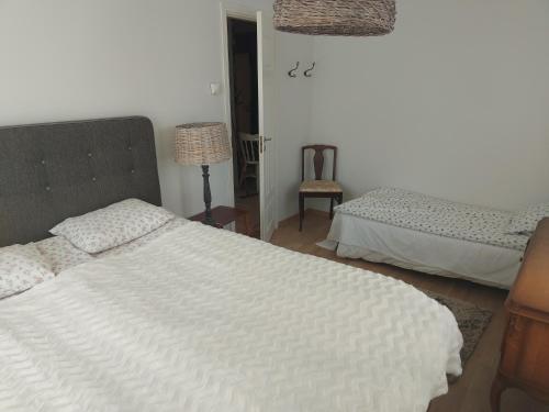 a bedroom with two beds and a lamp at Austri Villa in Pärnu