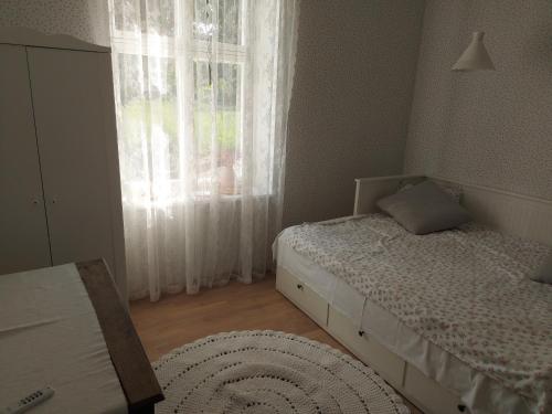 a bedroom with two beds and a window at Austri Villa in Pärnu