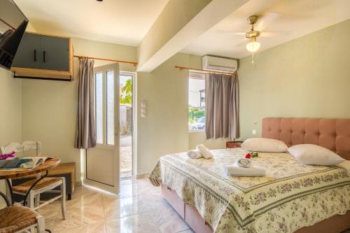 a bedroom with a large bed and a table and a table at Limonero New City Apartment 2 with Private Parking in Lefkada Town