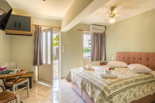 a bedroom with a large bed and a table and a table at Limonero New City Apartment 2 with Private Parking in Lefkada