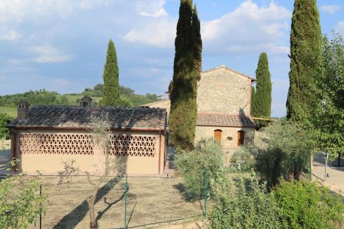 an old house with trees in front of it at Tenuta Sovestro - Agriturismo e winery in San Gimignano