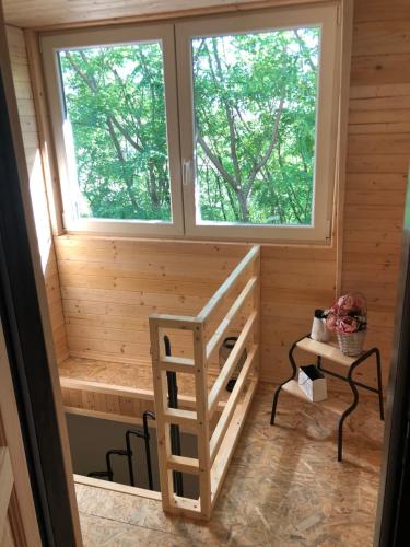 a cabin with two windows and a ladder in it at Sklípek-chatka Bella Moravia in Dobré Pole