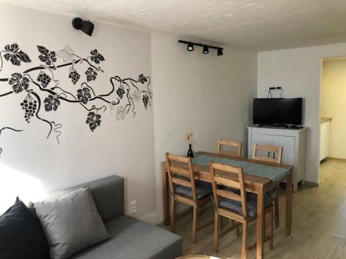 a living room with a table and a couch at Sklípek-chatka Bella Moravia in Dobré Pole