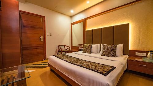 a bedroom with a large bed in a room at Uddhav Vilas A Family Hotel in Udaipur
