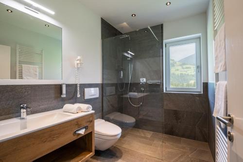 a bathroom with a sink toilet and a shower at Chalet Isabella in Kaltenbach