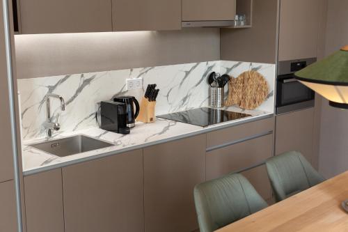 a kitchen with a sink and a counter top at BizStay Maurits in The Hague