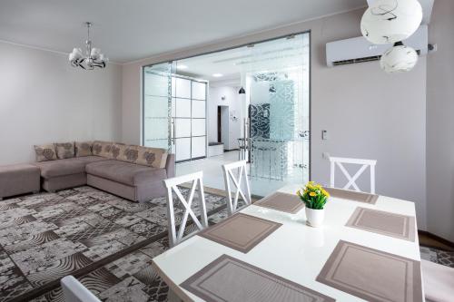a living room with a table and a couch at Oloy Apartment in Tashkent