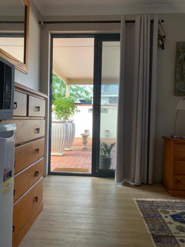 a kitchen with a sliding glass door to a patio at Forest Retreat Bed and Breakfast in Margaret River Town