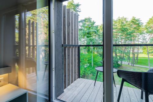 a view from the kitchen of a house with sliding glass doors at ESE HOTEL in Birštonas