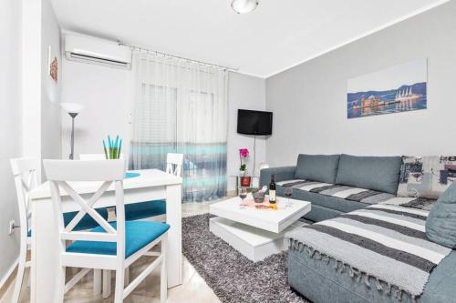 a living room with a couch and a table at Apartment Milos in Kotor