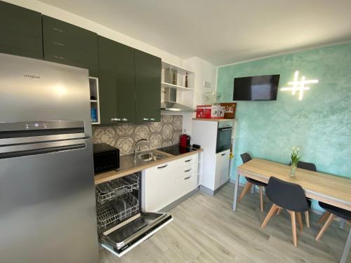 a kitchen with a table and a dining room at Mazzitelli Apartment in Capo Vaticano