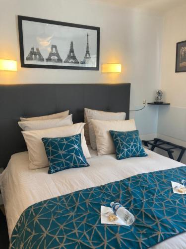 a bedroom with a large bed with blue and white pillows at Cannes City B&B in Cannes