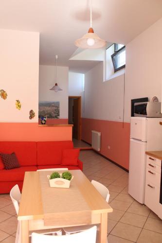 a living room with a red couch and a table at Il Turrione in Assisi