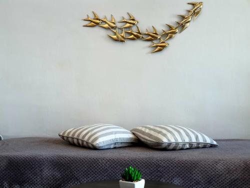 a bedroom with two pillows on a bed at Aqua & Terra Traditional Cave Houses in Oia