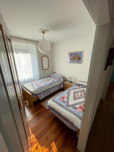 a room with two beds and a window in it at Casa da Rina in Siror