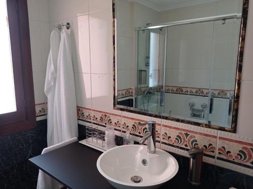 a bathroom with a sink and a mirror at Easo Terrace Apartment free private parking and air conditioning in San Sebastián