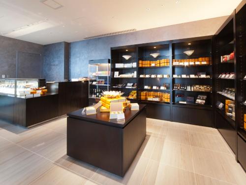 a wine shop with a counter and shelves of wine bottles at Osaka Marriott Miyako Hotel in Osaka
