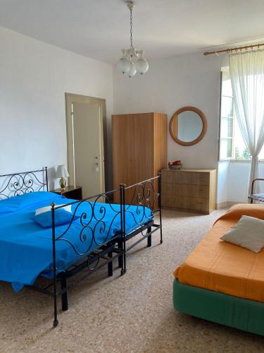 a bedroom with two beds and a mirror at Casa Milanda in Gargnano